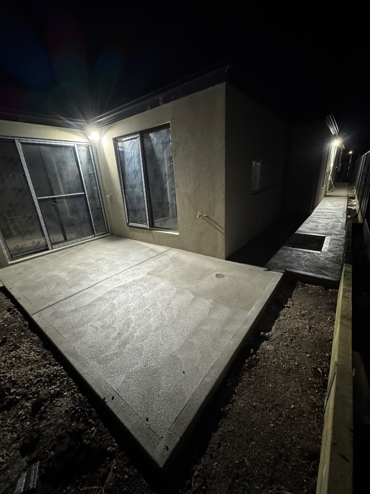 Finished alfresco slab and side path at night