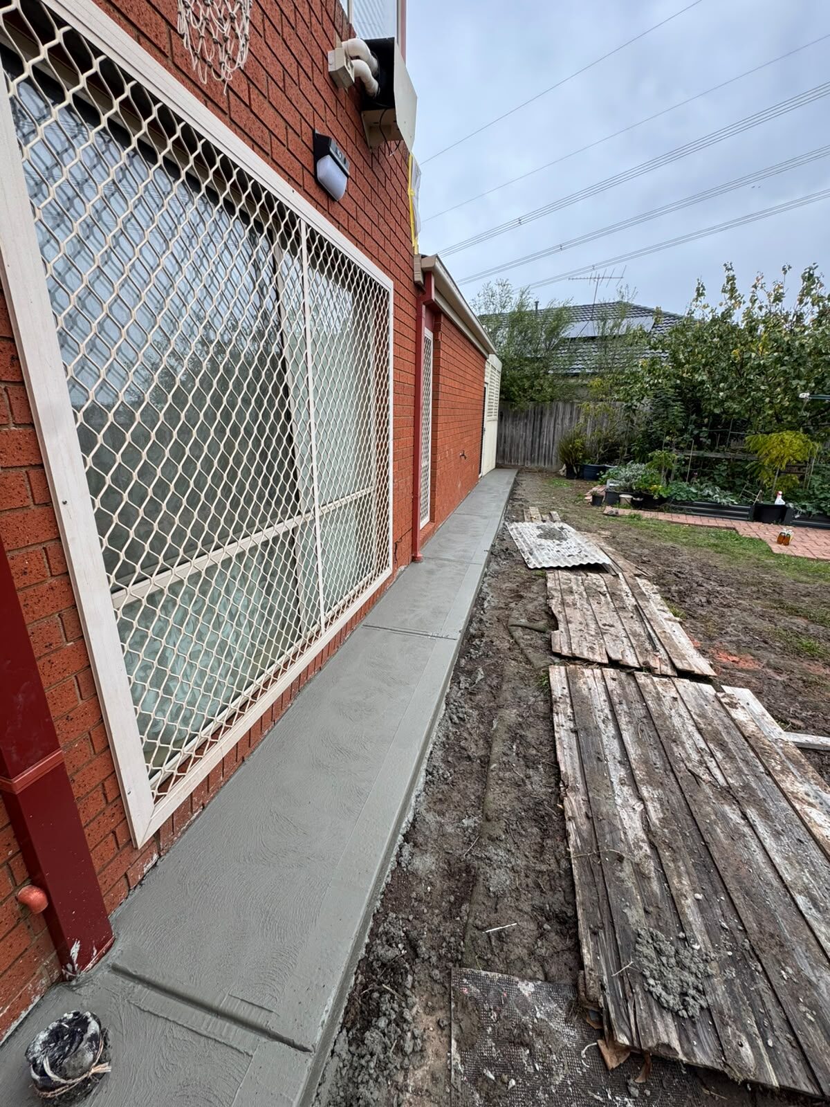 Concrete side path along a brick home