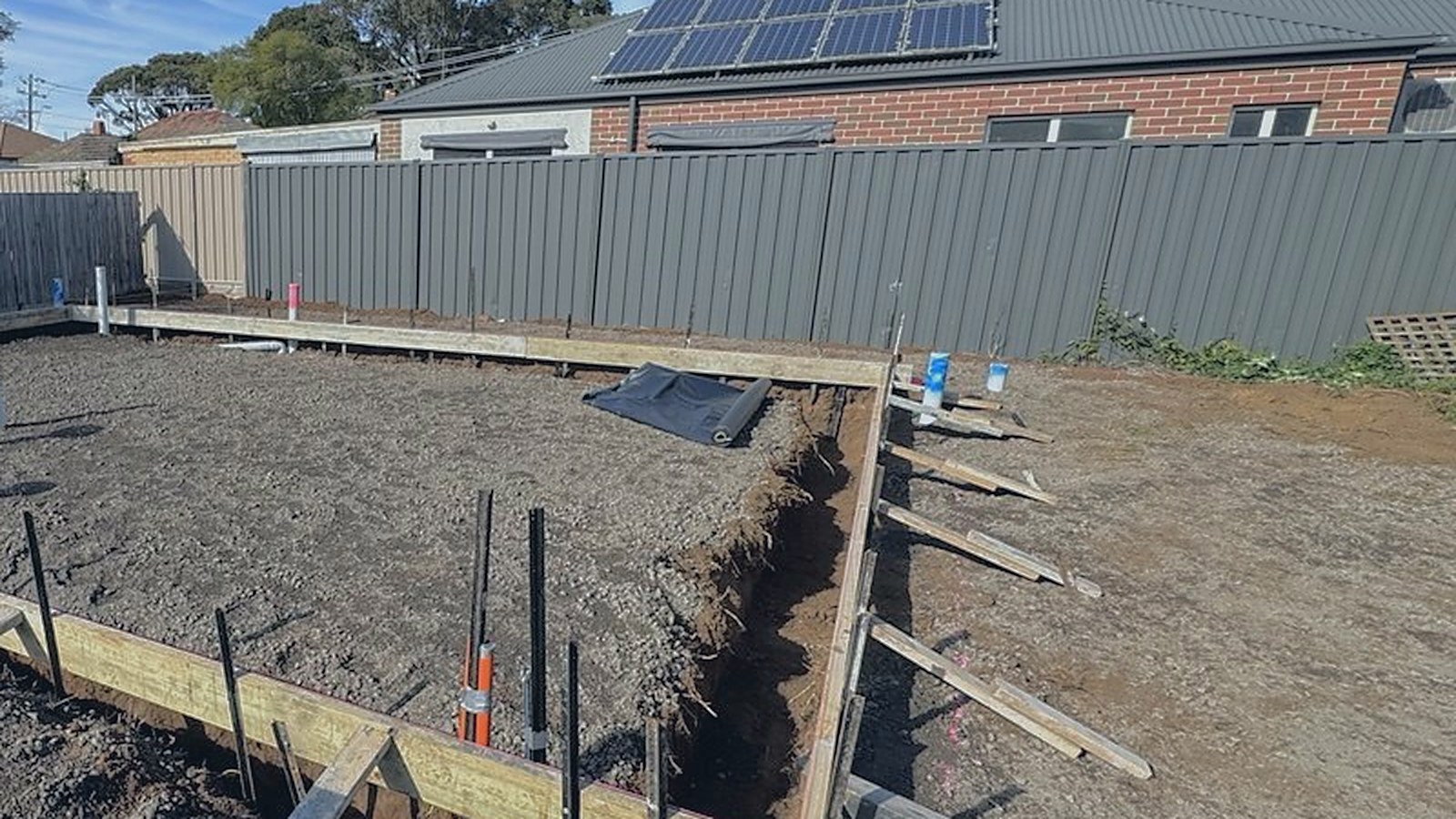 Excavated pad with formwork set out and plumbing stubs in place